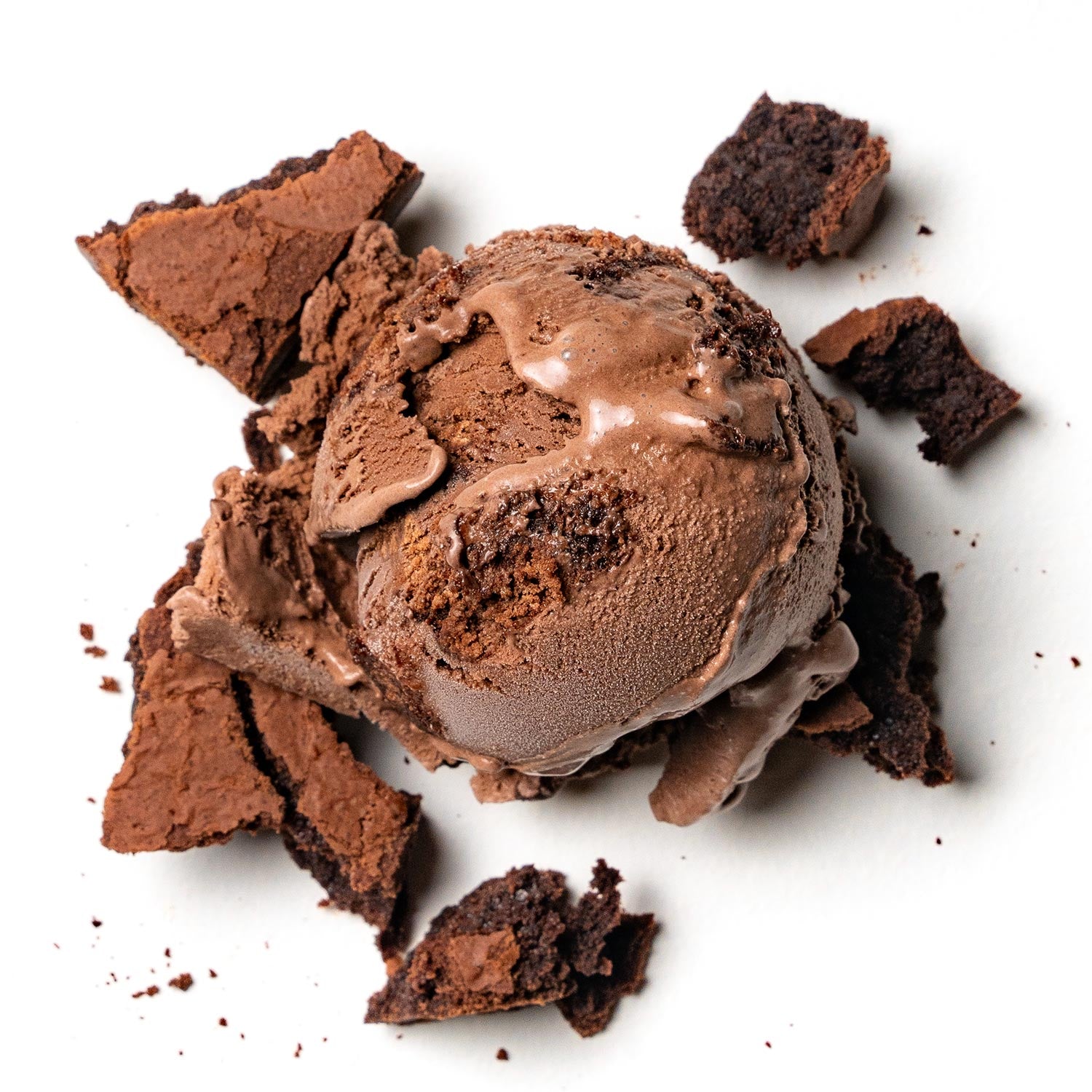 Dark Chocolate brownie ice cream scoop with chocolate cookie pieces on a white background