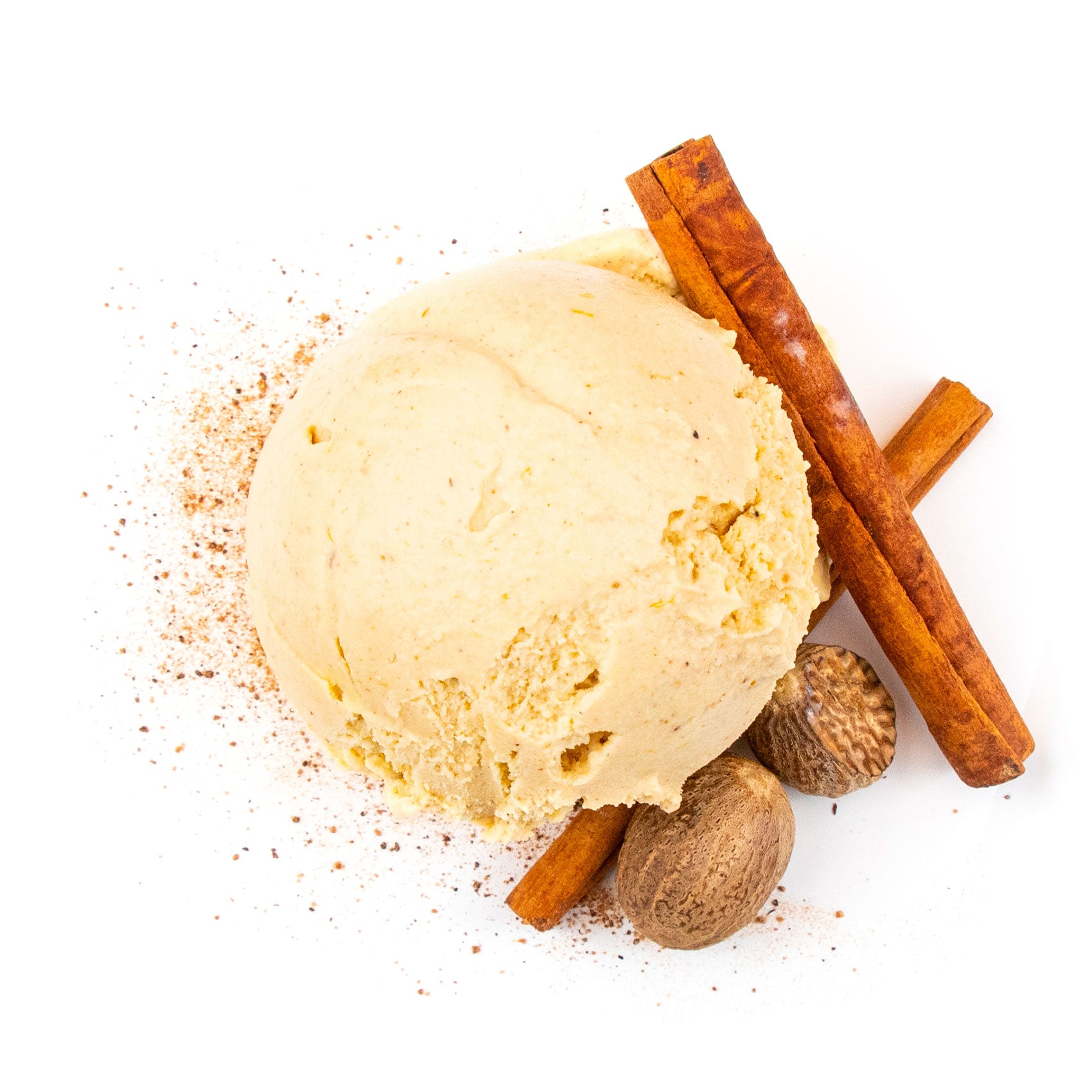 Pumpkin ice cream with cinnamon sticks and nutmeg on a white background